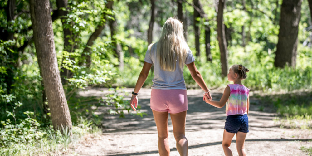 Women and young girl walking on path